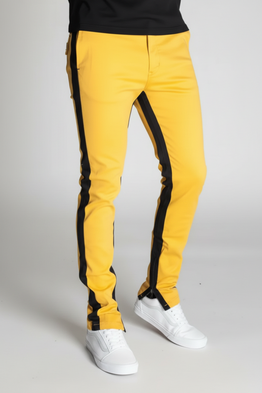 yellow pants with black stripes on the sides with zippers at the bottom ends